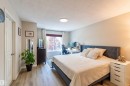 Spacious room featuring wood-finish flooring, a window offering natural light, and neutral wall tones - 8527 Ellis Link Nw, Edmonton, AB  - Indoor Photo Showing Bedroom 