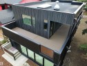 Modern multi-level exterior with black vertical siding and a flat roof - 8815 142 Street Nw, Edmonton, AB 