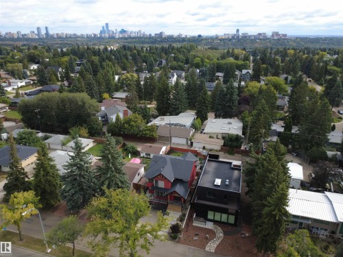 Contemporary exterior with a flat roofline, dark facade, and expansive windows - 8815 142 Street Nw, Edmonton, AB 