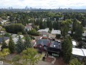 Contemporary exterior with a flat roofline, dark facade, and expansive windows - 8815 142 Street Nw, Edmonton, AB 