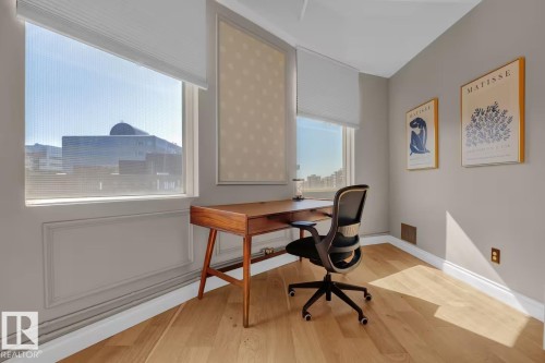 Wood-finish flooring with crisp white baseboards - #904 10105 109 St Nw, Edmonton, AB 