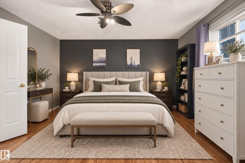 Wood-finish flooring, ceiling fan with integrated lighting, window with blinds, panel door with brass-finish hardware, built-in shelving unit - 9826 180 Avenue Nw, Edmonton, AB 