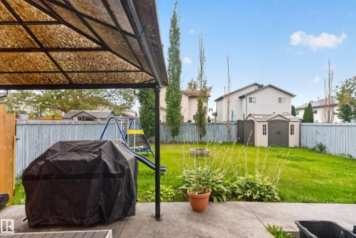 Private fenced yard featuring a storage shed and mature trees - 9826 180 Avenue Nw, Edmonton, AB 