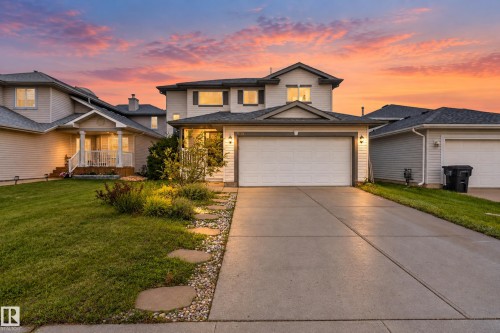 Two-story residence featuring light-toned siding, dark shingle roofing, and a two-car attached garage - 9826 180 Avenue Nw, Edmonton, AB 