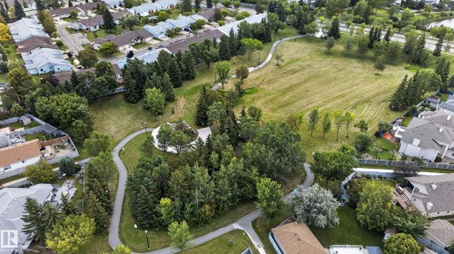 Expansive parkland with paved pathways, mature trees, and open green spaces, surrounded by residential properties - 9826 180 Avenue Nw, Edmonton, AB 