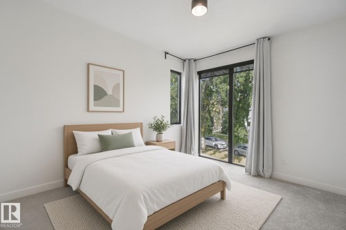 Recessed lighting, large windows with black frames, and light gray carpet flooring - 10925 University Avenue Nw, Edmonton, AB 