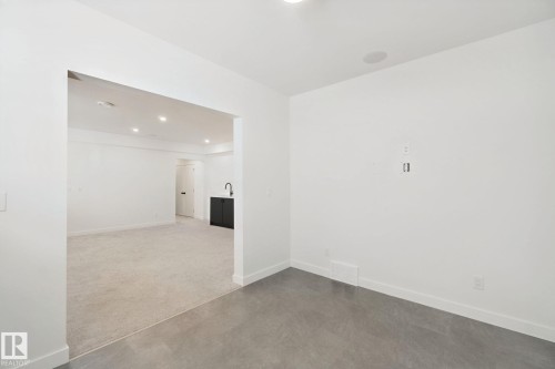 Recessed lighting, wood-finish flooring, and white walls - 10925 University Avenue Nw, Edmonton, AB 