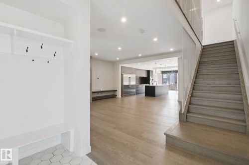 Entryway featuring built-in bench and coat hooks - 10925 University Avenue Nw, Edmonton, AB 