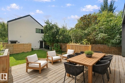 Spacious wood-finish deck with integrated planters - 10925 University Avenue Nw, Edmonton, AB 