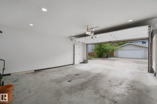 Spacious garage with concrete flooring, recessed lighting, and an automatic garage door opener - 10925 University Avenue Nw, Edmonton, AB 