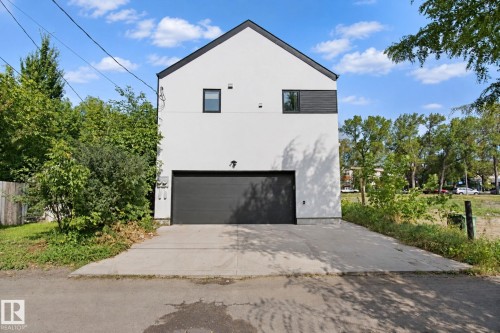 Modern architectural design with a gabled roofline and a stark white exterior - 10925 University Avenue Nw, Edmonton, AB 