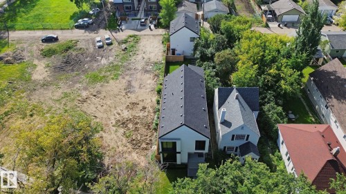 Expansive lot featuring cleared land ready for development, surrounded by mature trees and established residential properties - 10925 University Avenue Nw, Edmonton, AB 