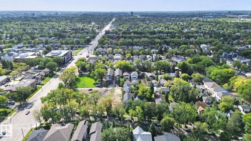 Expansive residential area with mature tree canopies, featuring a prominent thoroughfare and a mix of single-family homes and multi-story buildings - 10925 University Avenue Nw, Edmonton, AB 