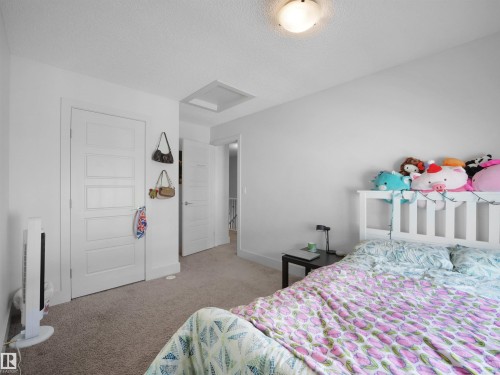 White interior doors with a multi-panel design, textured ceiling, and flush-mount ceiling light - #40 2003 Rabbit Hill Rd Nw, Edmonton, AB 