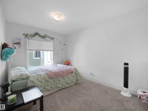 Window with horizontal blinds, overhead flush mount light fixture, and light-colored wall-to-wall carpeting - #40 2003 Rabbit Hill Rd Nw, Edmonton, AB 