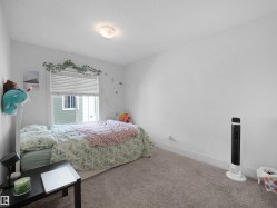 Window with horizontal blinds, overhead flush mount light fixture, and light-colored wall-to-wall carpeting - 