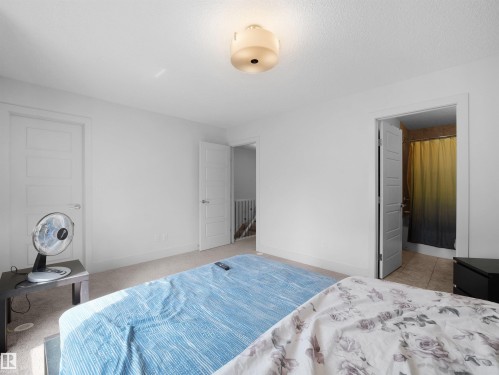 Carpeted flooring, smooth white walls, recessed lighting, and a light-colored ceiling fixture - #40 2003 Rabbit Hill Rd Nw, Edmonton, AB 
