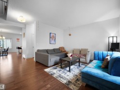 Hardwood-finish flooring throughout, bright white walls, recessed lighting, and a modern light fixture - 