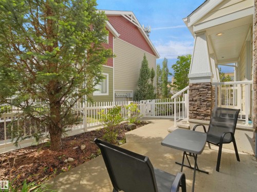 Front porch featuring stone accent column and concrete patio - #40 2003 Rabbit Hill Rd Nw, Edmonton, AB 