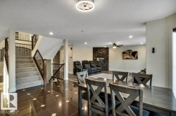 Two-story staircase with wrought iron balusters and carpeted treads - 