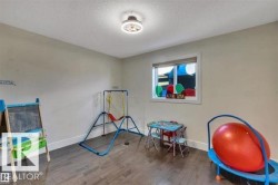 Neutral tone walls with white baseboards and wood-finish flooring - 