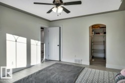 Room featuring light-toned walls, wood-finish flooring, and a ceiling fan with light fixture - 