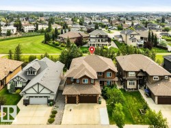 Two-story residence featuring a multi-gable roofline and attached two-car garage - 