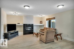 Living area featuring light wood-finish flooring and neutral wall tones - 