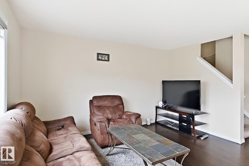 Hardwood-style flooring throughout the main living area - 2829 18A Avenue Nw, Edmonton, AB 