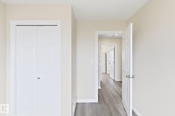 Neutral wall tones, panel-style interior doors, bi-fold closet doors, and wood-finish flooring - 