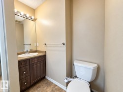 Vanity with a wood-finish cabinet, integrated sink, and laminate countertop - 