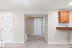 Neutral wall paint, light-toned carpeting, and white interior doors - 