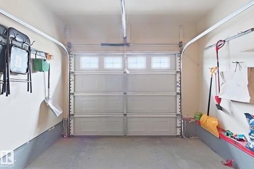 Attached garage with overhead door featuring top-row windows - 2829 18A Avenue Nw, Edmonton, AB 
