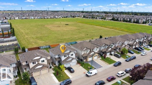 Residential street with detached homes, each featuring an attached garage and front driveways - 2829 18A Avenue Nw, Edmonton, AB 