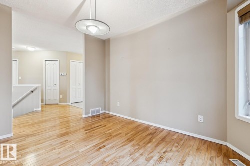 Polished wood-finish flooring, recessed lighting, and a contemporary ceiling fixture - 1190 Potter Greens Drive Nw, Edmonton, AB 