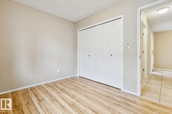 Wood-finish flooring, neutral wall paint, and bi-fold closet doors - 