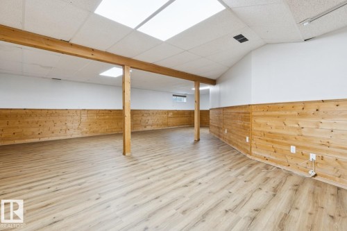 Wood-finish flooring, wood paneling, drop ceiling with recessed lighting, exposed structural beam - 1190 Potter Greens Drive Nw, Edmonton, AB 