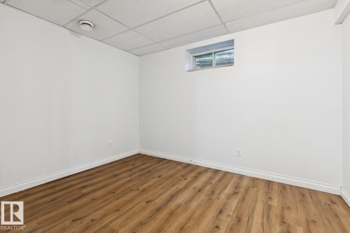 Recessed window, wood-finish flooring, white walls, and drop panel ceiling - 1190 Potter Greens Drive Nw, Edmonton, AB 