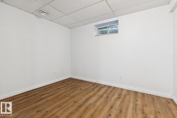 Recessed window, wood-finish flooring, white walls, and drop panel ceiling - 