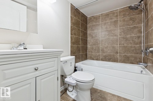 White vanity with under-sink storage, integrated sink, and chrome faucet - 1190 Potter Greens Drive Nw, Edmonton, AB 