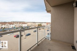 Private balcony featuring glass panel railings and a concrete floor - 