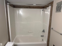 Tub and shower combination with chrome fixtures and grab bar - 
