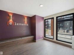 Recessed ceiling lighting, wall-mounted sconces, large windows with black trim, built-in bench seating with dark cushions, and tile flooring - 