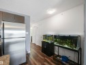 Wood-finish flooring throughout, stainless steel refrigerator, and recessed ceiling lighting - #414 340 Windermere Rd Nw, Edmonton, AB 