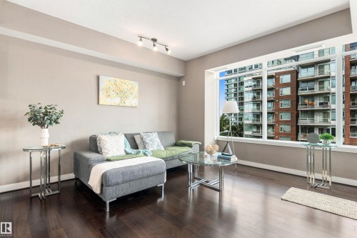 Expansive windows, track lighting, crown molding, wide baseboards, and dark wood-finish flooring - #416 2510 109 St Nw, Edmonton, AB 