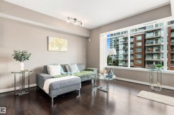 Expansive windows, track lighting, crown molding, wide baseboards, and dark wood-finish flooring - 