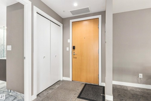 Entryway with wood-finish door, smart lock, and recessed lighting - #416 2510 109 St Nw, Edmonton, AB 