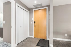 Entryway with wood-finish door, smart lock, and recessed lighting - 