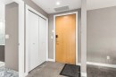 Entryway with wood-finish door, smart lock, and recessed lighting - #416 2510 109 St Nw, Edmonton, AB 