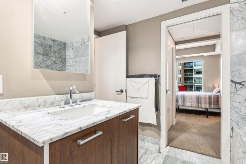 Marble vanity with an integrated sink and chrome faucet - #416 2510 109 St Nw, Edmonton, AB 